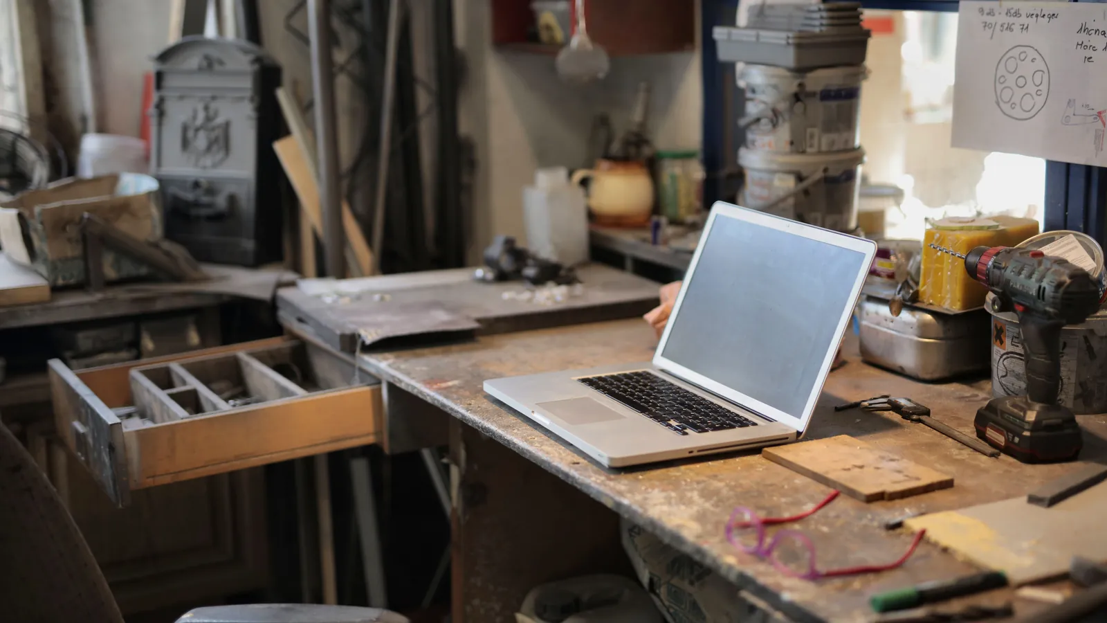 Laptop and tools on a workshop bench